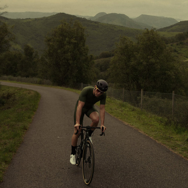 Cyclist riding a hill road
