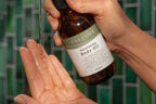 Nourishing Body Oil being poured into the palm of a hand - Adelaide Hills Organics